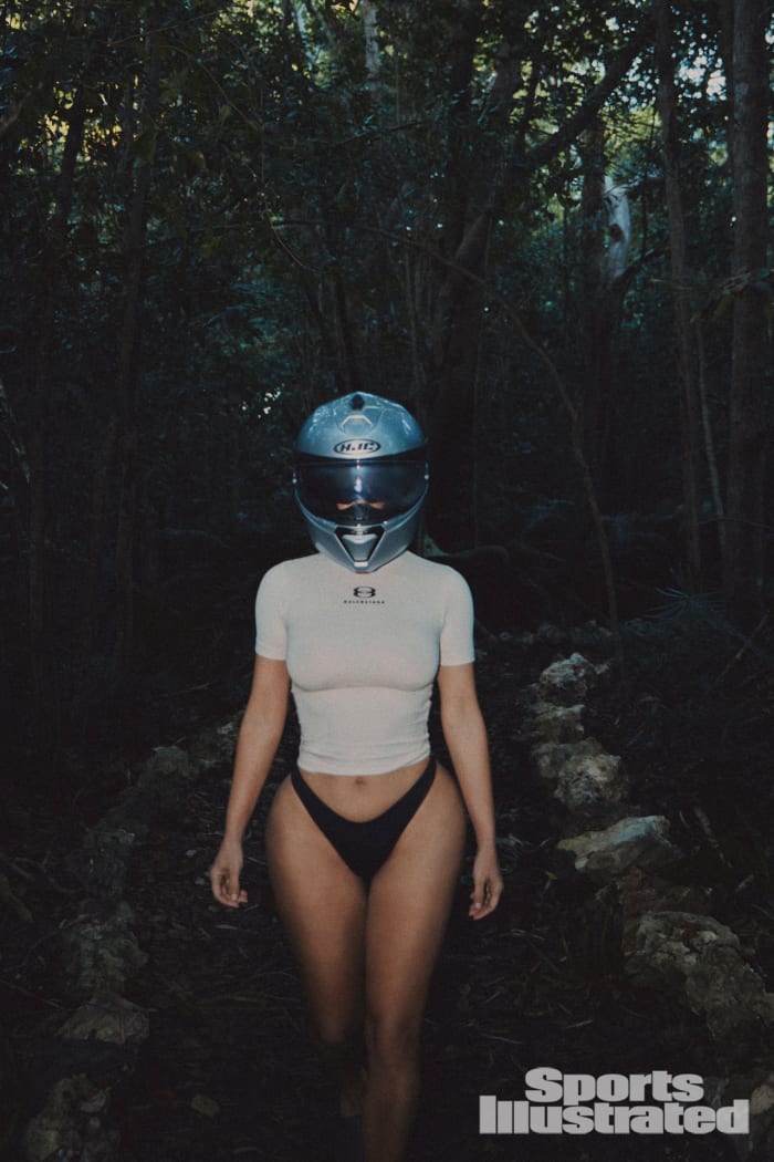 Kim Kardashian was photographed by Greg Swales in the Dominican Republic. Swimsuit by SKIMS. Top by Balenciaga. Helmet by HJC.